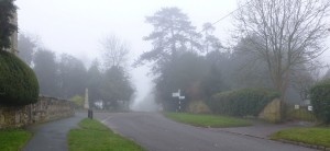 Temperature inversion near Swanbourne Church produces mist that hangs on the hill top.